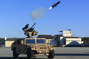 A military vehicle with a missile on top of it.
